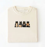 Flat lay of a Cute black cat baker shirt featuring baking cats with bread and mixing bowl on cream t-shirt on a white background 