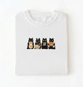 Flat lay of a Cute black cat baker shirt featuring baking cats with bread and mixing bowl on white t-shirt on a white background 