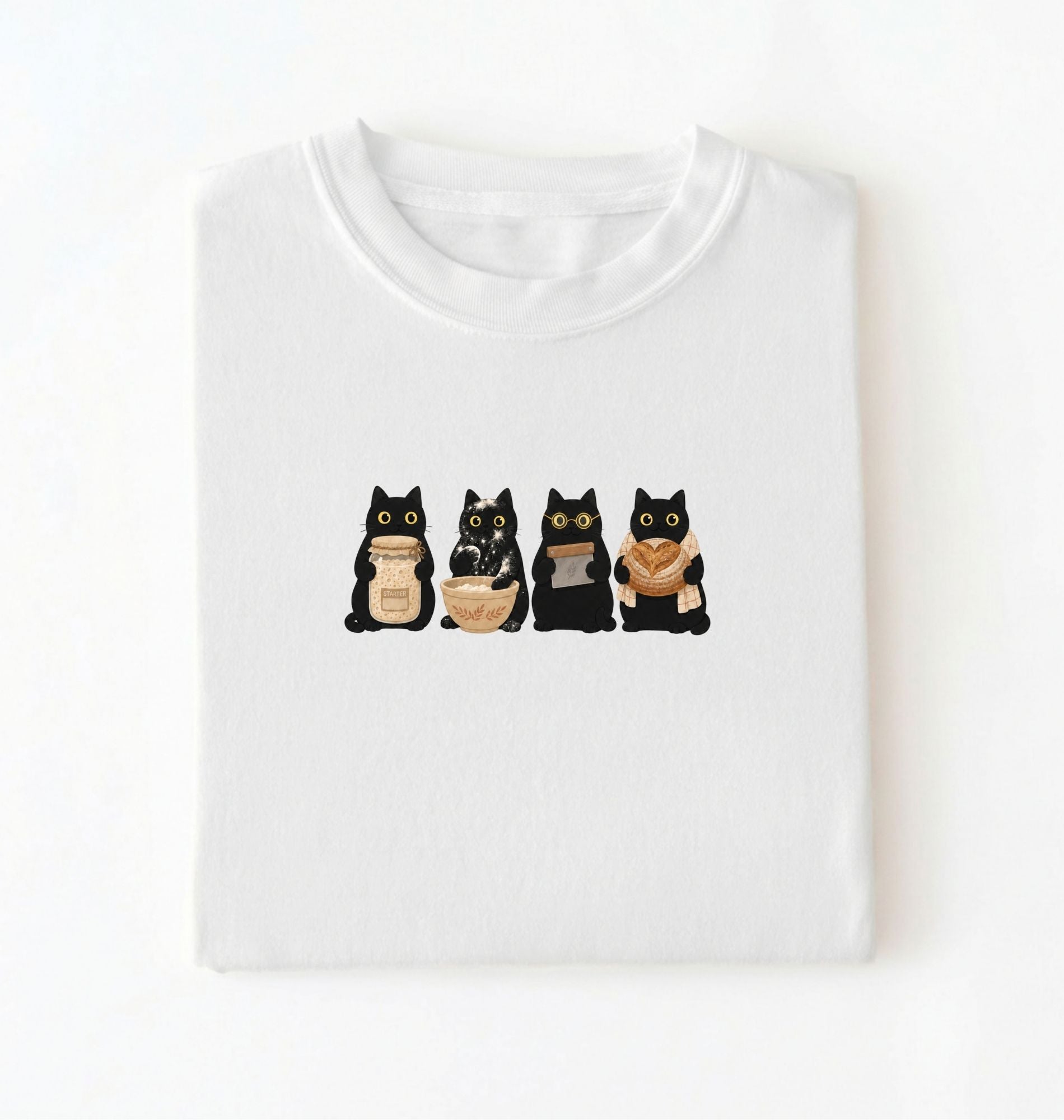 Flat lay of a Cute black cat baker shirt featuring baking cats with bread and mixing bowl on white t-shirt on a white background 