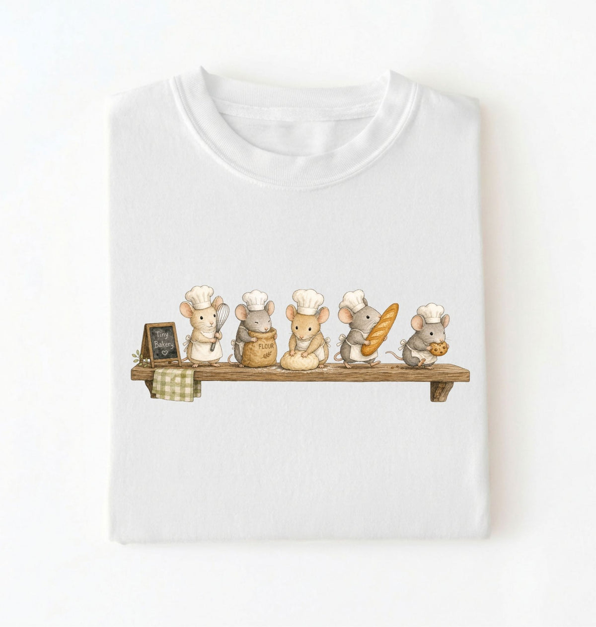 A white short-sleeve crewneck t-shirt featuring a printed graphic of five cute cartoon mice dressed as bakers on a wooden shelf, displayed against a clean white background.