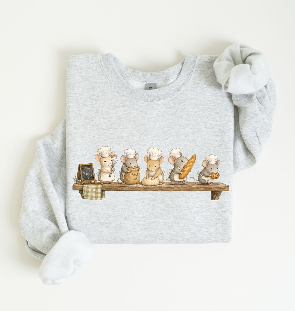 A light heather gray long-sleeve sweatshirt with a graphic of five cute cartoon mice dressed as chefs sitting on a wooden shelf, displayed flat on a warm off-white background.