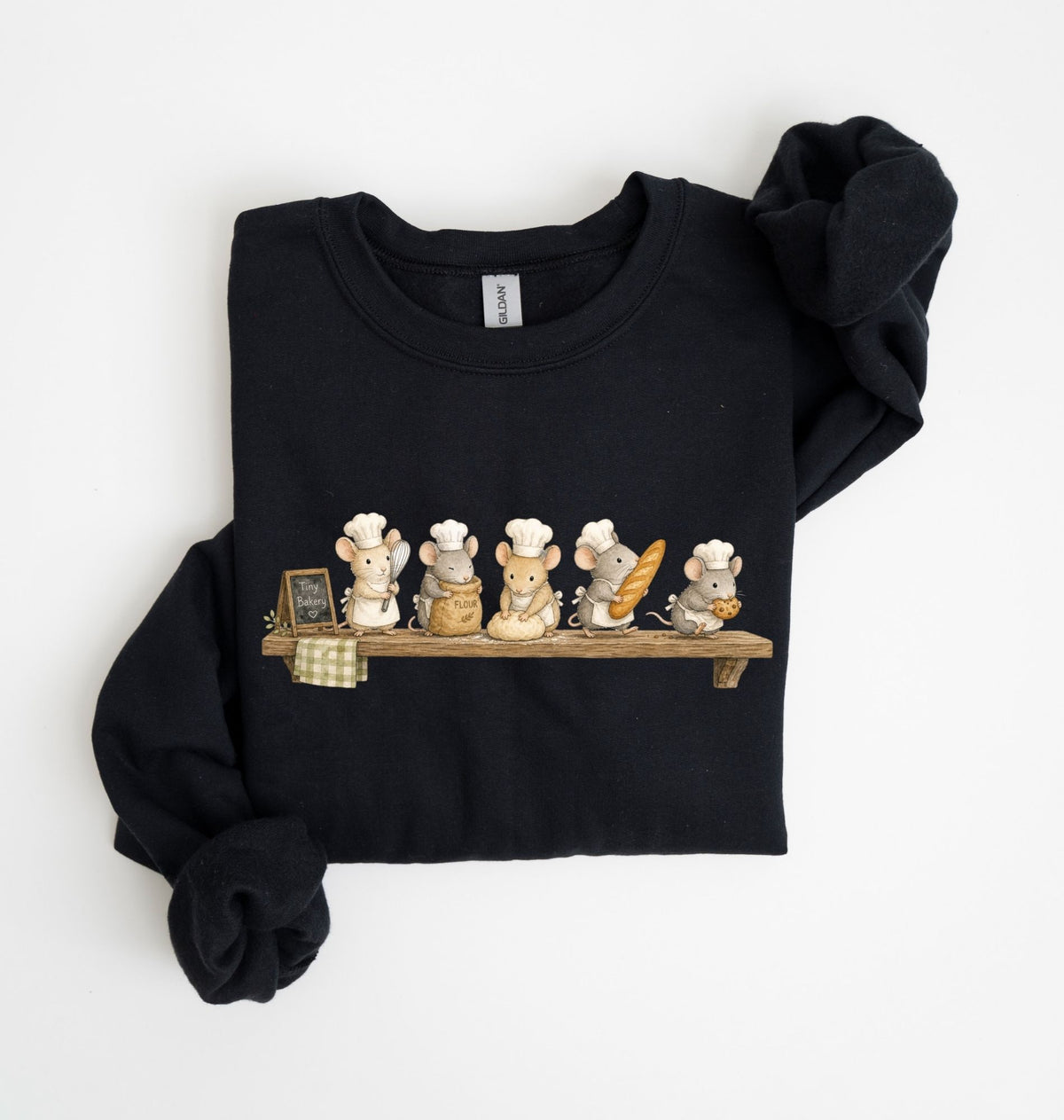 A black long-sleeve sweatshirt with rolled cuffs, featuring a graphic print of five cute chef mice sitting on a wooden shelf. The sweatshirt is laid flat on a clean white background.