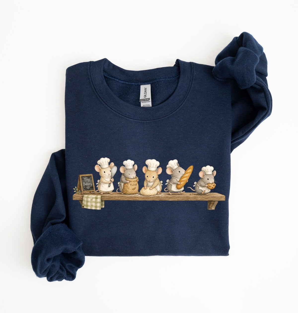 A navy blue long-sleeve sweatshirt with rolled cuffs, featuring a printed graphic of five cartoon mice wearing chef hats and holding baking utensils on a wooden shelf. The sweatshirt is displayed flat on a white background with one sleeve folded over the other.