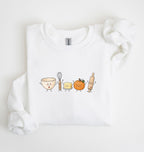 A white long-sleeve crewneck sweatshirt featuring a cute graphic of cartoon kitchen utensils (a mixing bowl, whisk, butter, pumpkin, and rolling pin) on the chest, displayed on a clean white background.