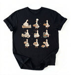 Flat lay of a Cute goose baker shirt with sourdough bread and cottagecore baking artwork on black tee on a white background 