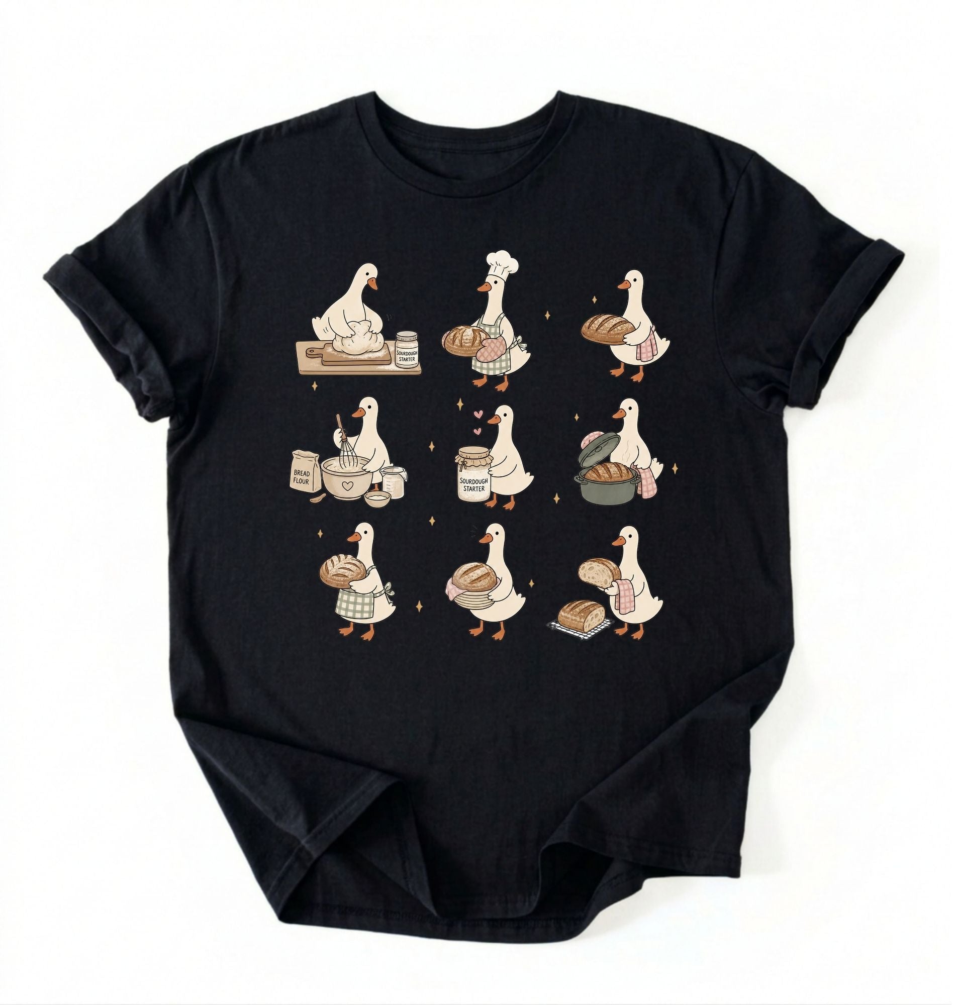 Flat lay of a Cute goose baker shirt with sourdough bread and cottagecore baking artwork on black tee on a white background 