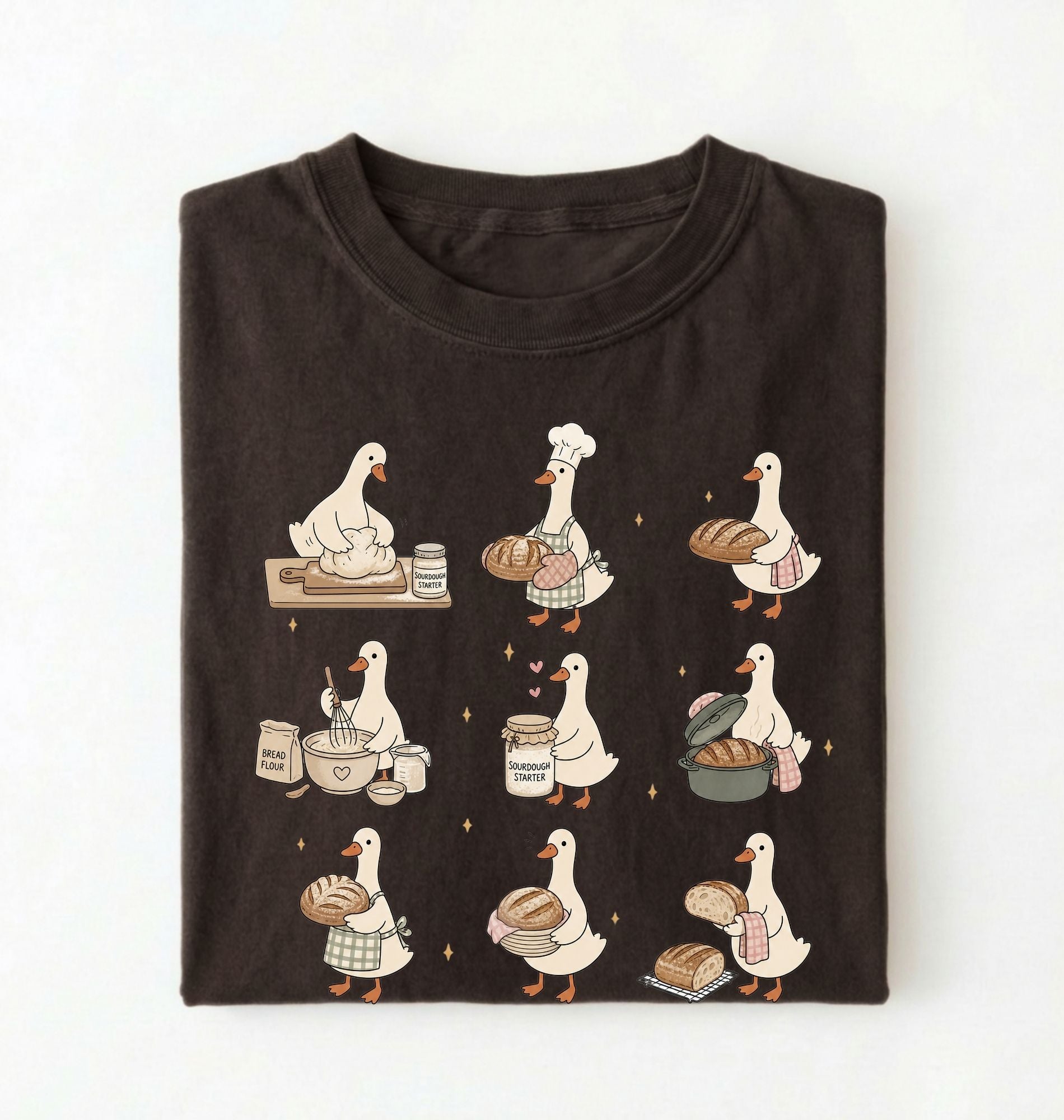 Flat lay of a Cute goose baker shirt with sourdough bread and cottagecore baking artwork on brown tee on a white background 