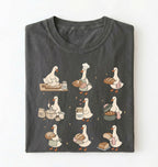 Flat lay of a Cute goose baker shirt with sourdough bread and cottagecore baking artwork on pepper tee on a white background 