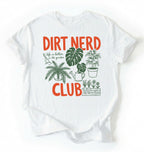 Flat lay of a white t-shirt featuring plant illustrations and bold text reading “Dirt Nerd Club.” on a white background