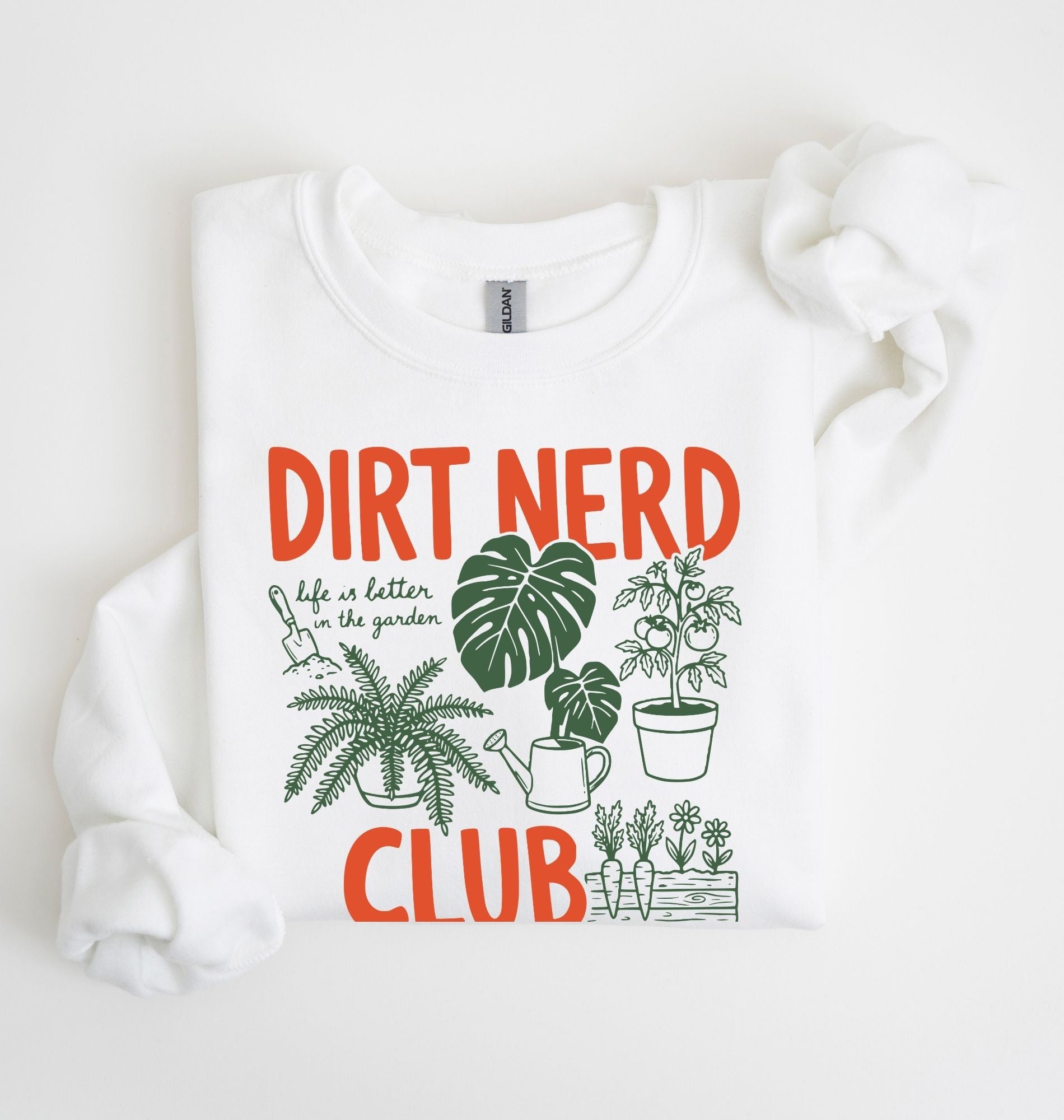 Flat lay of a white Dirt nerd club sweatshirt with plant illustrations perfect gift for gardeners plant lovers and nature enthusiasts on a white background
