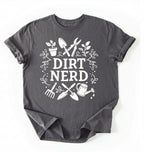 Flat lay of a charcoal Dirt nerd gardening shirt with tools and plant illustrations perfect gift for gardeners and plant lovers on a white background