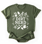 Flat lay of a military green Dirt nerd gardening shirt with tools and plant illustrations perfect gift for gardeners and plant lovers on a white background