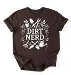 Flat lay of a dark chocolate Dirt nerd gardening shirt with tools and plant illustrations perfect gift for gardeners and plant lovers on a white background 