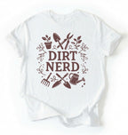 Flat lay of a white Dirt nerd gardening shirt with tools and plant illustrations perfect gift for gardeners and plant lovers on a white background
