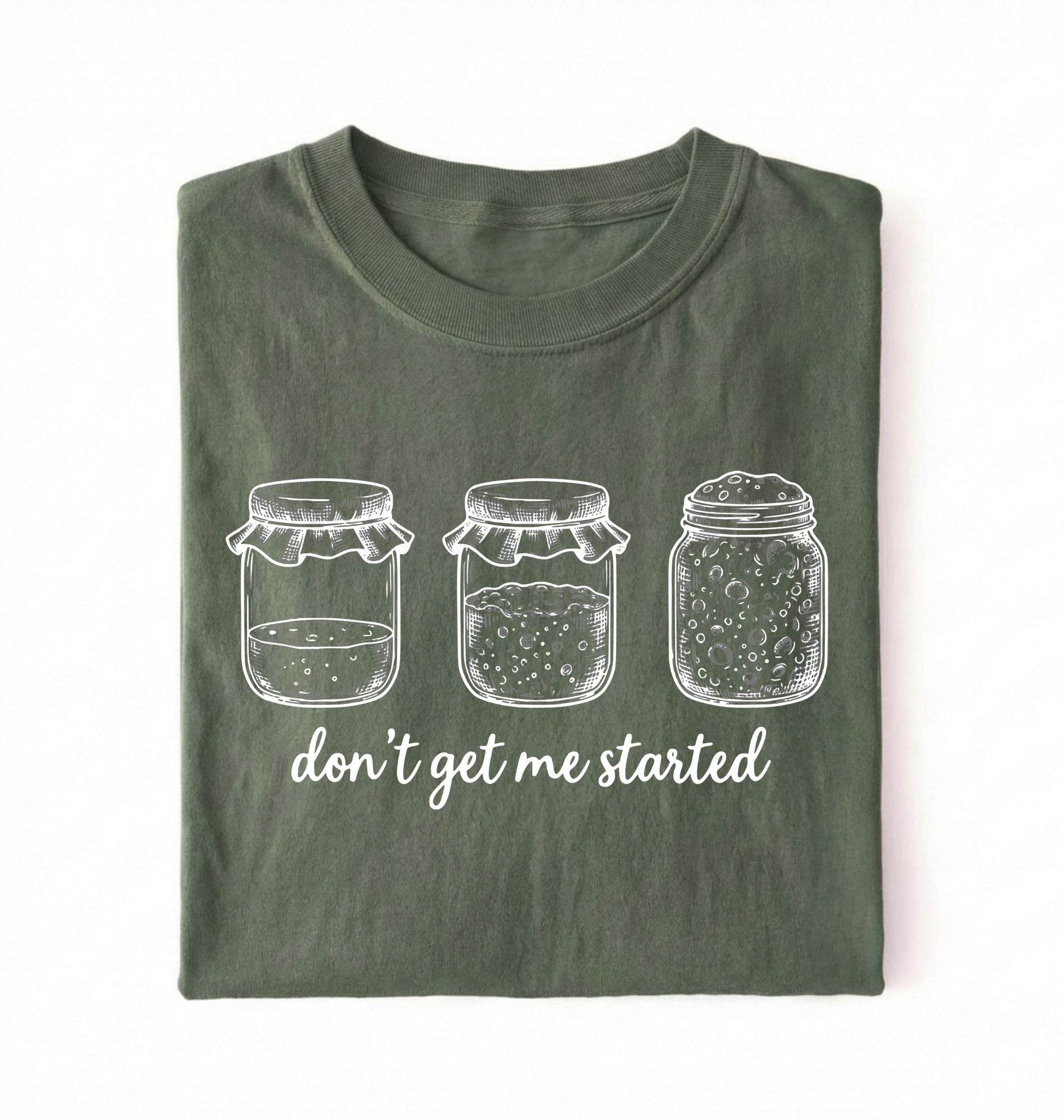 Flat lay of a moss Funny sourdough shirt with starter jars illustration perfect gift for bakers and fermentation lovers on a white background