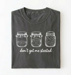 Flat lay of a pepper Funny sourdough shirt with starter jars illustration perfect gift for bakers and fermentation lovers on a white background
