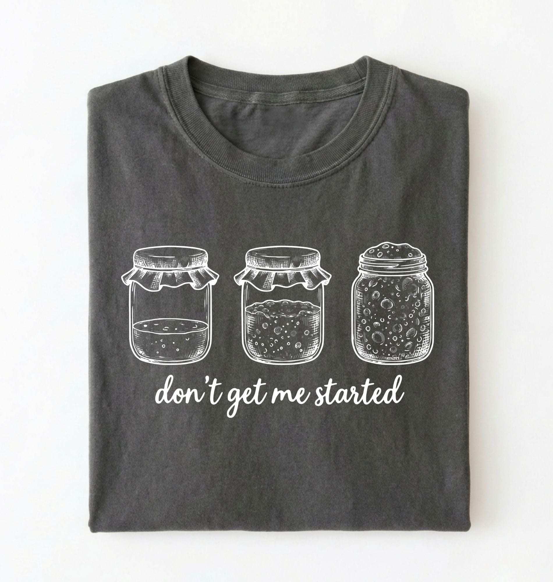 Flat lay of a pepper Funny sourdough shirt with starter jars illustration perfect gift for bakers and fermentation lovers on a white background