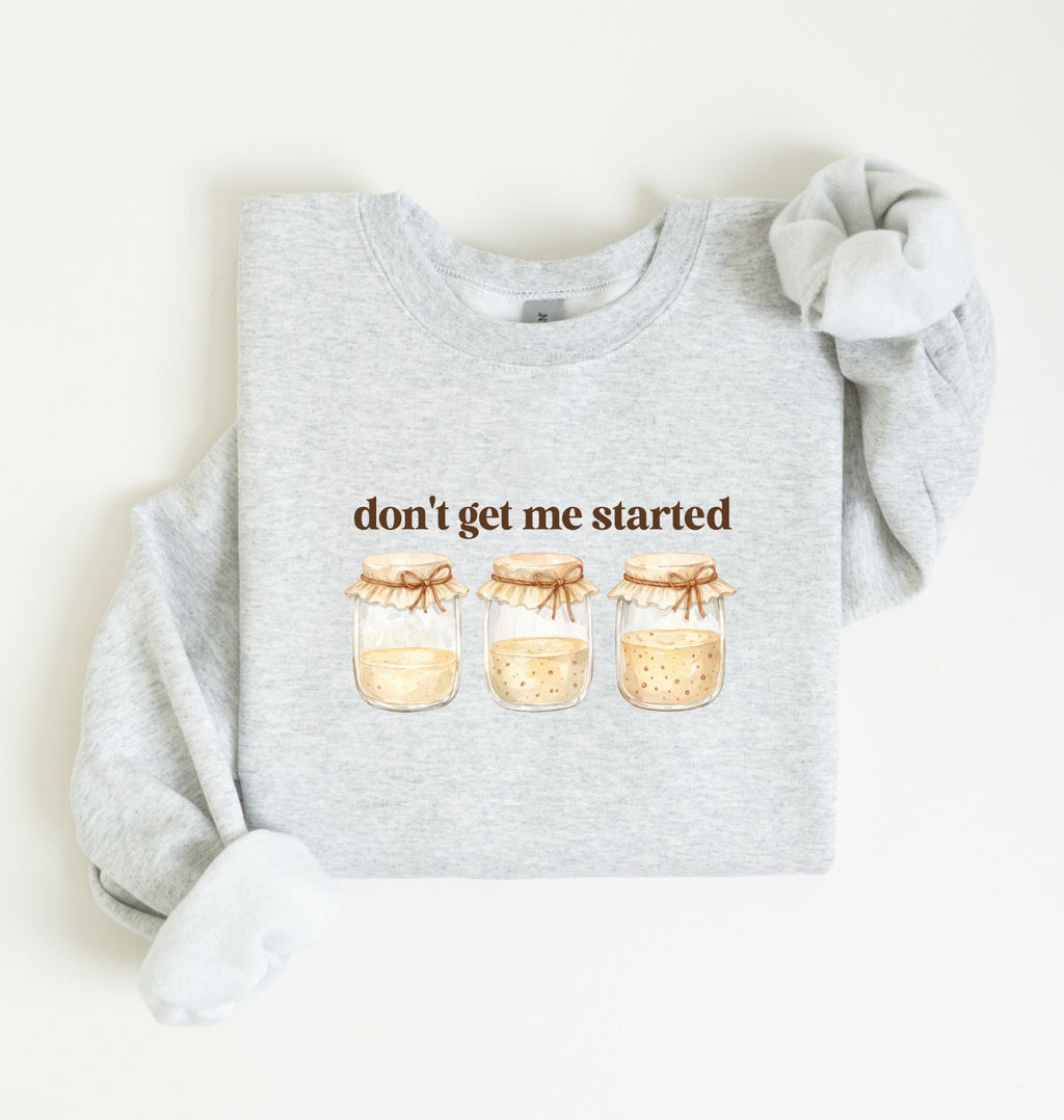 Flat lay of an ash Cottagecore kitchen sweatshirt with jars illustration cozy baking lover gift on a white background 