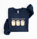 Flat lay of a navy Cottagecore kitchen sweatshirt with jars illustration cozy baking lover gift on a white background 