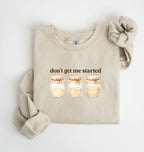 Flat lay of a sand Cottagecore kitchen sweatshirt with jars illustration cozy baking lover gift on a white background 