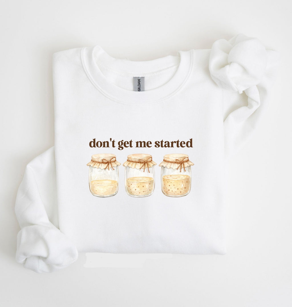 Flat lay of a white Cottagecore kitchen sweatshirt with jars illustration cozy baking lover gift on a white background 
