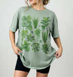 Person wearing a Botanical plant illustration shirt with green houseplants, perfect gardener gift for plant lovers and nature fans on a sage background 