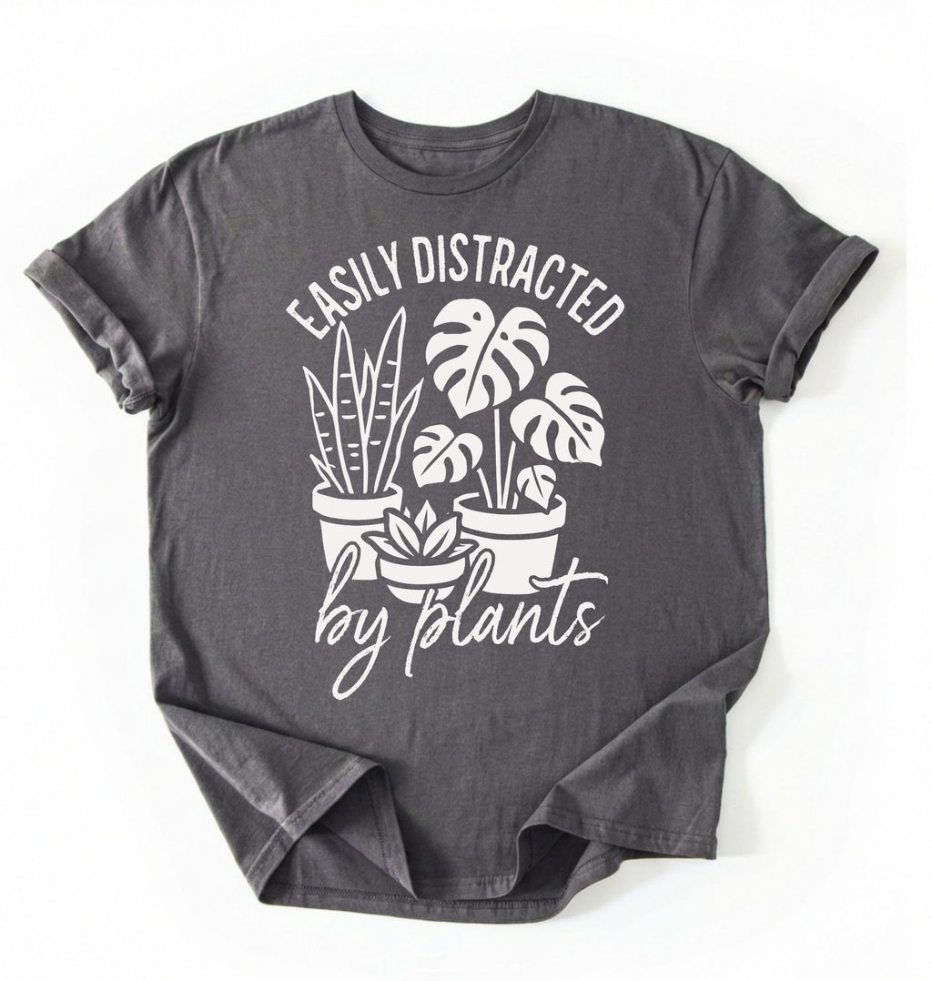 A Charcoal color shirt with a text written "easily distracted by plants" with houseplant illustration plant lover gift on a white background 