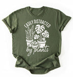 A moss color shirt with a text written "easily distracted by plants" with houseplant illustration plant lover gift on a white background 