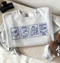 Flat lay of an Embroidered Baking Addict Sourdough Mama sweatshirt with vintage baking stamp design