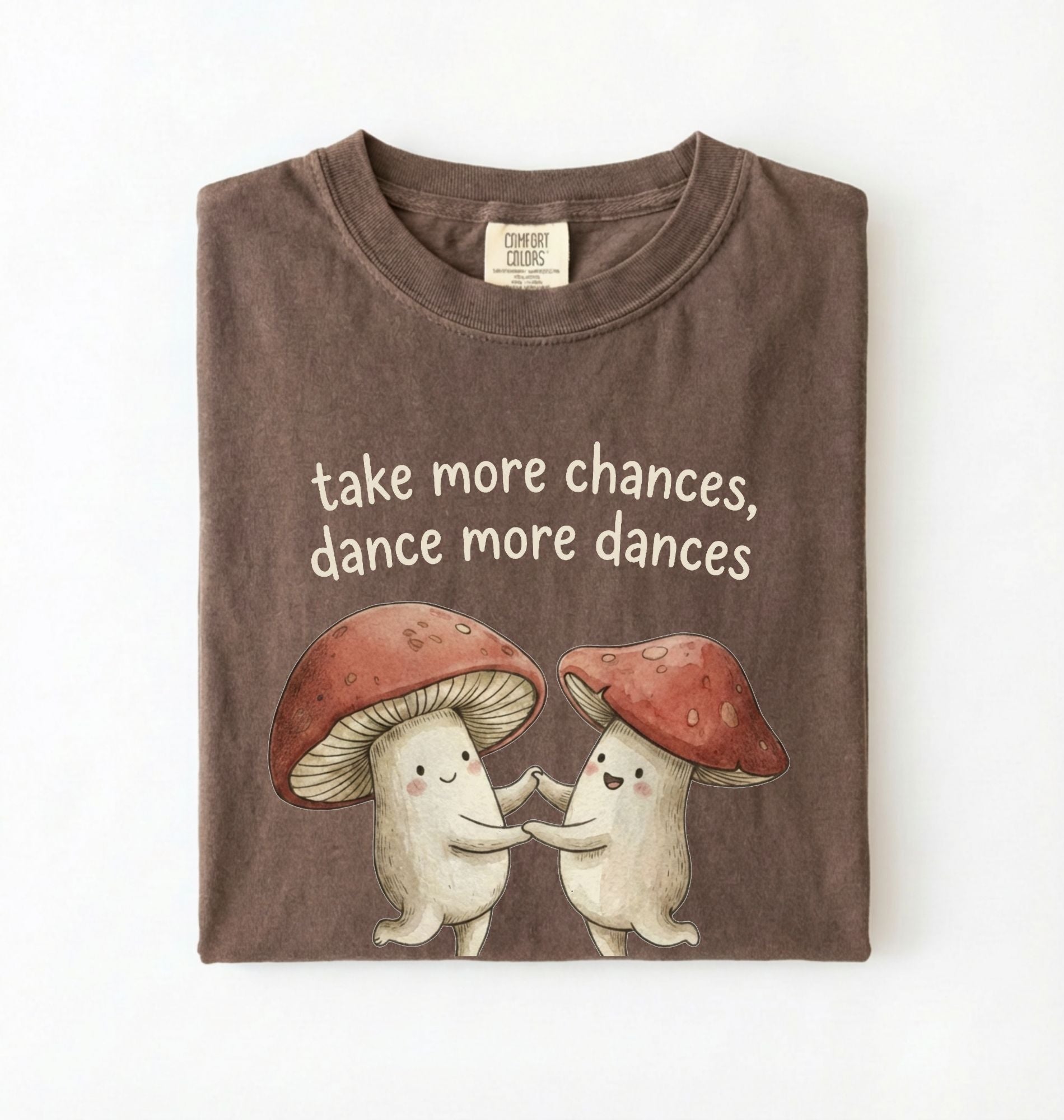 Espresso t-shirt with two dancing mushrooms and the phrase take more chances dance more dances, whimsical cottagecore gift tee