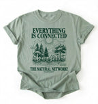 Flat lay of a Bay_Sage t-shirt featuring a forest and fungi illustration with text reading “Everything Is Connected The Natural Network.” perfect gift for nature lovers and eco friendly lifestyle on a white background 