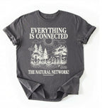 Flat lay of a Charcoal t-shirt featuring a forest and fungi illustration with text reading “Everything Is Connected The Natural Network.” perfect gift for nature lovers and eco friendly lifestyle on a white background 