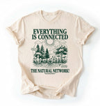 Flat lay of a natural t-shirt featuring a forest and fungi illustration with text reading “Everything Is Connected The Natural Network.” perfect gift for nature lovers and eco friendly lifestyle on a white background 