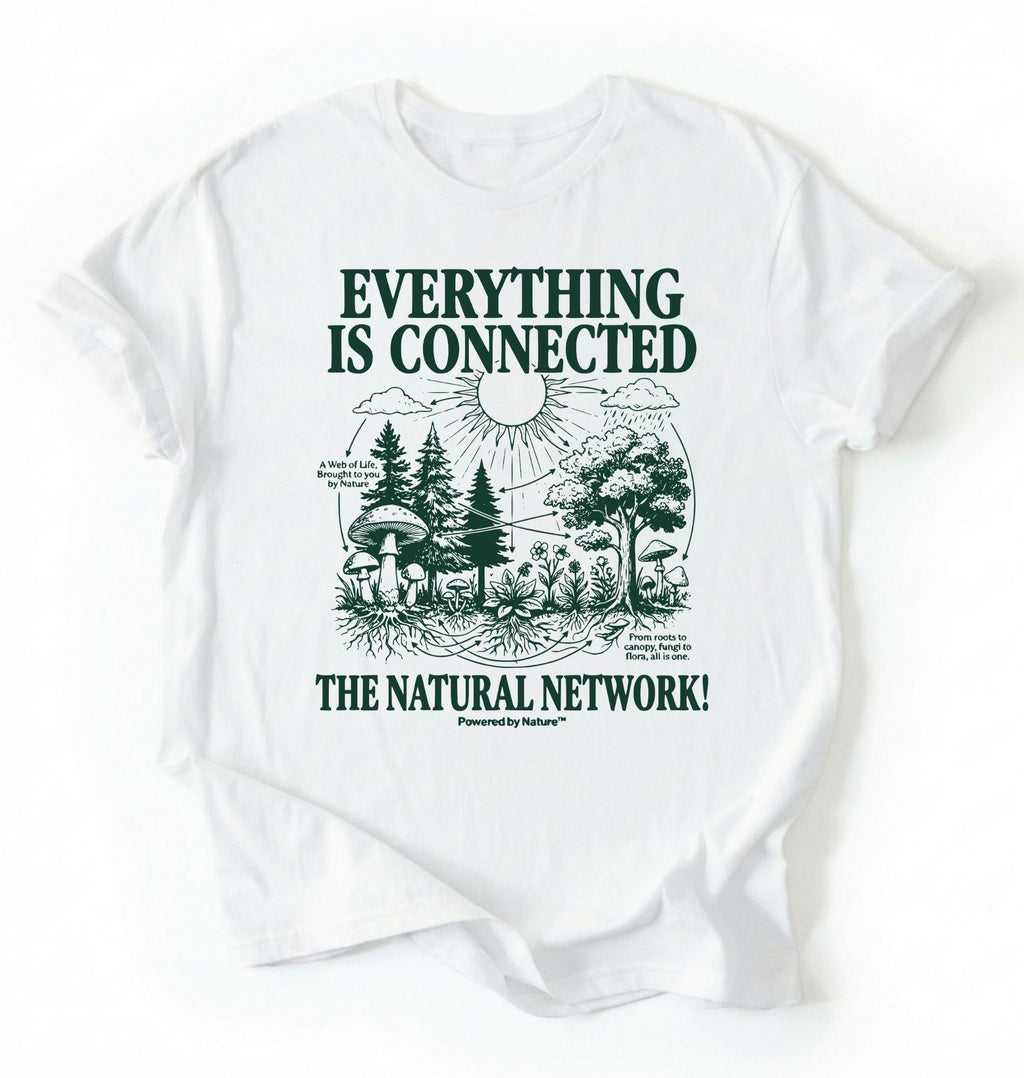 Flat lay of a white t-shirt featuring a forest and fungi illustration with text reading “Everything Is Connected The Natural Network.” perfect gift for nature lovers and eco friendly lifestyle on a white background 