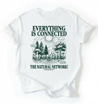 Flat lay of a white t-shirt featuring a forest and fungi illustration with text reading “Everything Is Connected The Natural Network.” perfect gift for nature lovers and eco friendly lifestyle on a white background 