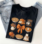Flat lay of a black fall baking shirt featuring pumpkin pies, pumpkins, autumn leaves, a stand mixer, baking apron and orange bow on a white background 