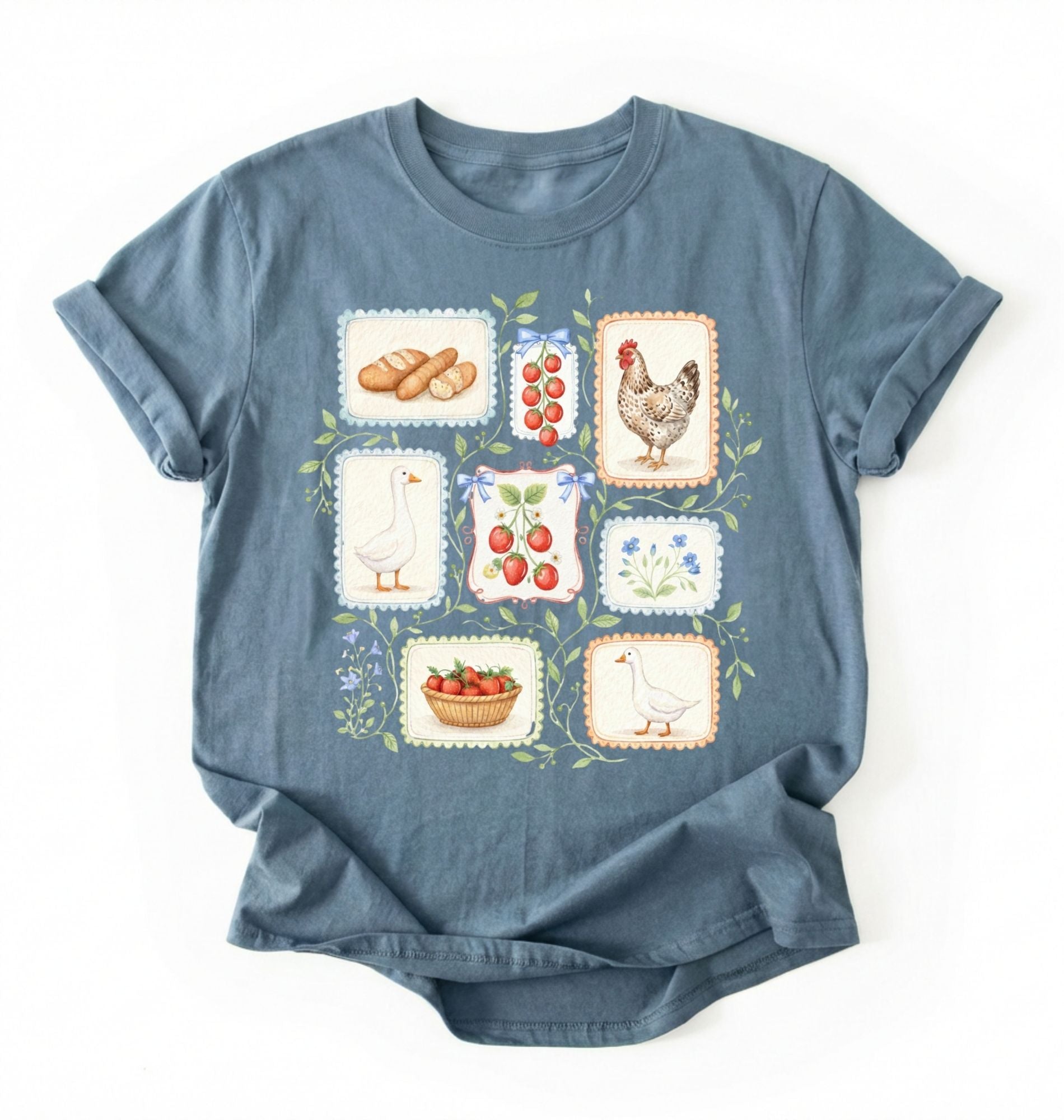Flat lay of a stoneblue t-shirt featuring vintage-style illustrations of bread, eggs, fruit, and chickens arranged in a grid pattern perfect homestead gardener gift for farm life lovers on a white background 