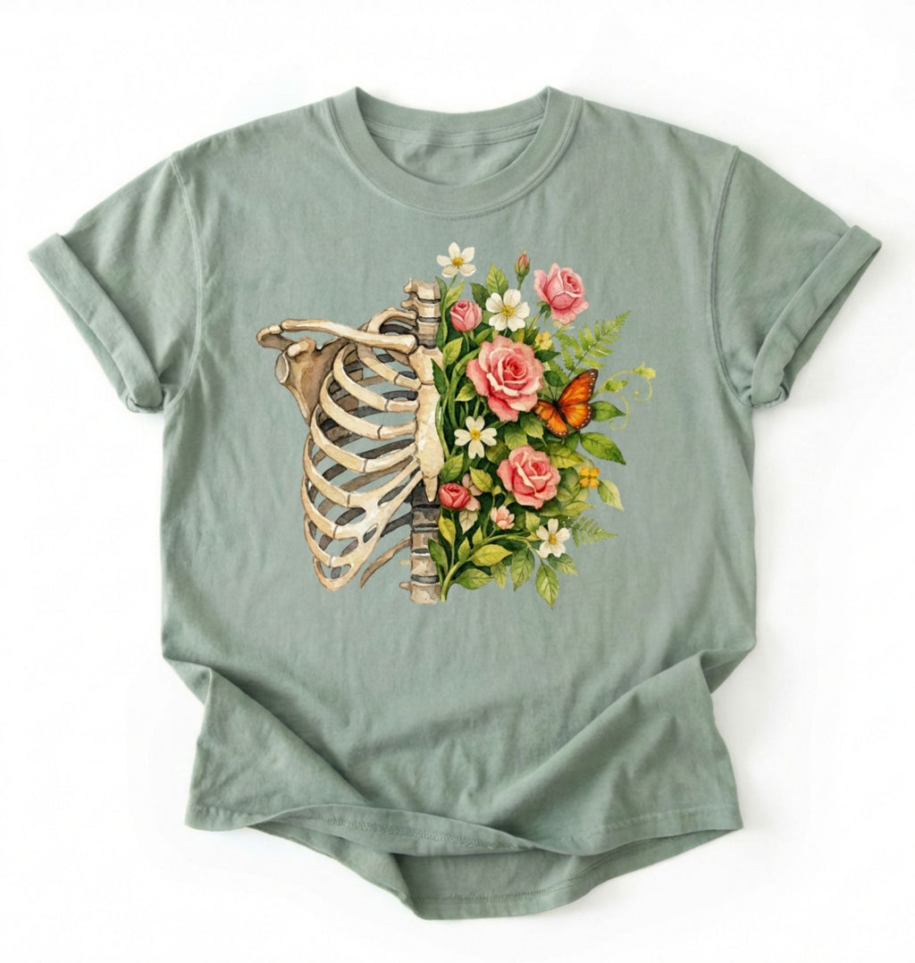 Flat lay of a Bay Floral ribcage t-shirt with botanical flowers and butterfly, artistic skeleton plant lover gift on a white background