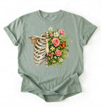 Flat lay of a Bay Floral ribcage t-shirt with botanical flowers and butterfly, artistic skeleton plant lover gift on a white background
