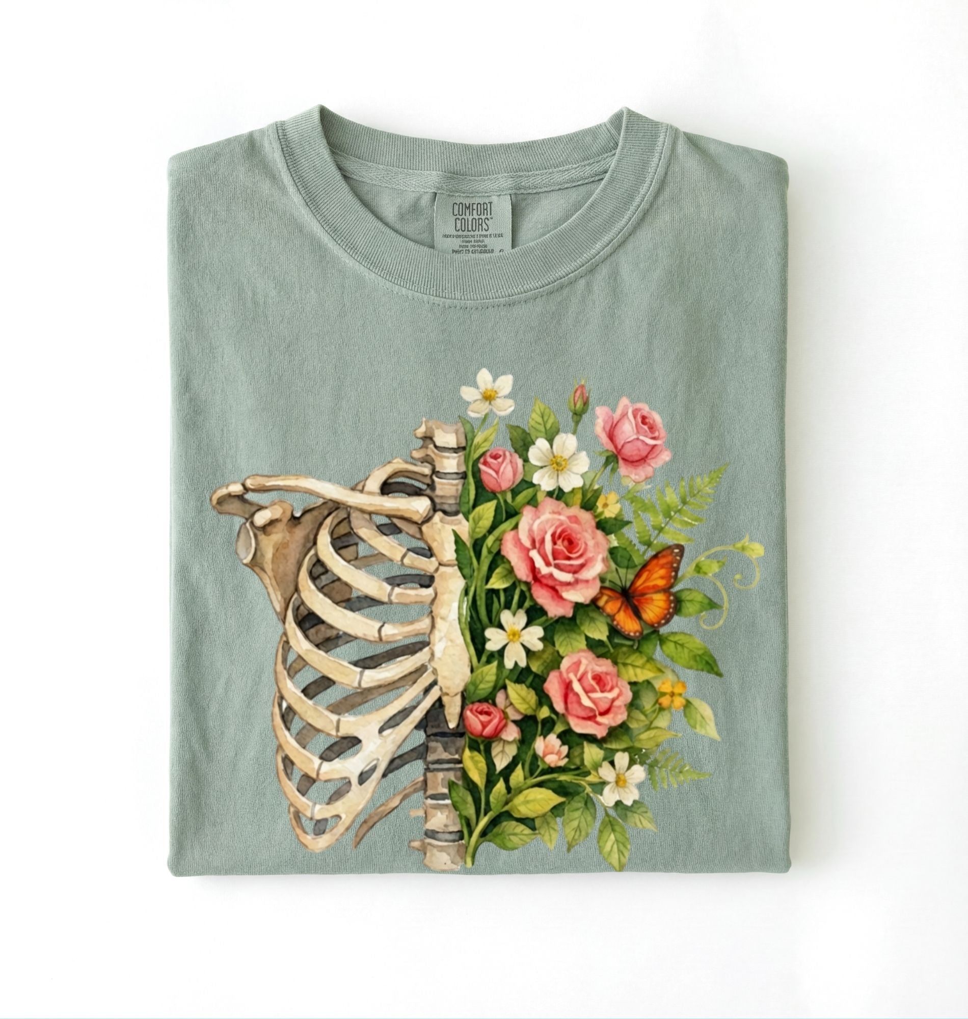 Flat lay of a Bay Floral ribcage t-shirt with botanical flowers and butterfly, artistic skeleton plant lover gift on a white background