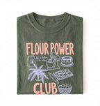 Flat lay of a green flour power club shirt with stand mixer cake cookies and baking illustrations funny baker gift on a white background 