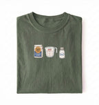 Flat lay of a green flour water salt shirt with flour bag measuring cup and salt shaker minimalist bread baker gift on a white background 