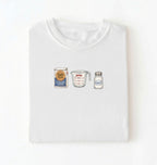 Flat lay of a white flour water salt shirt with flour bag measuring cup and salt shaker minimalist bread baker gift on a white background 