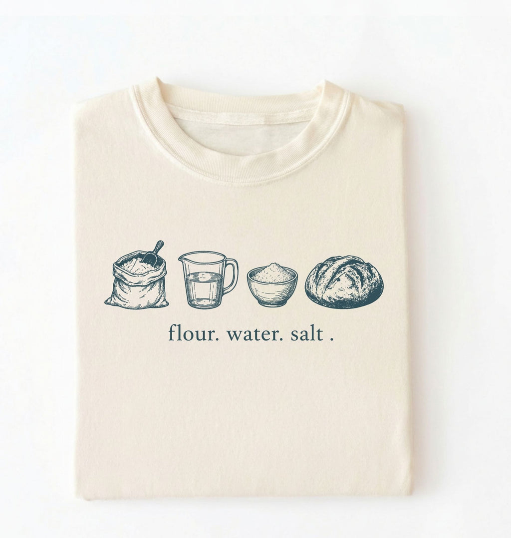 Flat lay of an ivory flour water salt shirt cream minimalist baking t shirt bread lover gift sourdough aesthetic design on a white background 