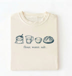 Flat lay of an ivory flour water salt shirt cream minimalist baking t shirt bread lover gift sourdough aesthetic design on a white background 