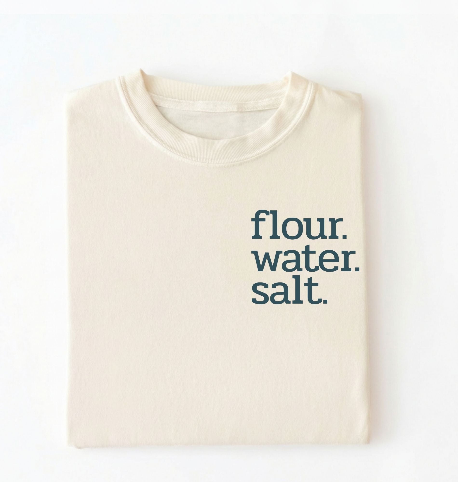 Flat lay of an ivory flour water salt shirt black minimalist sourdough baking t shirt bread lover gift simple design on a white background 