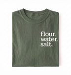 Flat lay of a green flour water salt shirt black minimalist sourdough baking t shirt bread lover gift simple design on a white background 