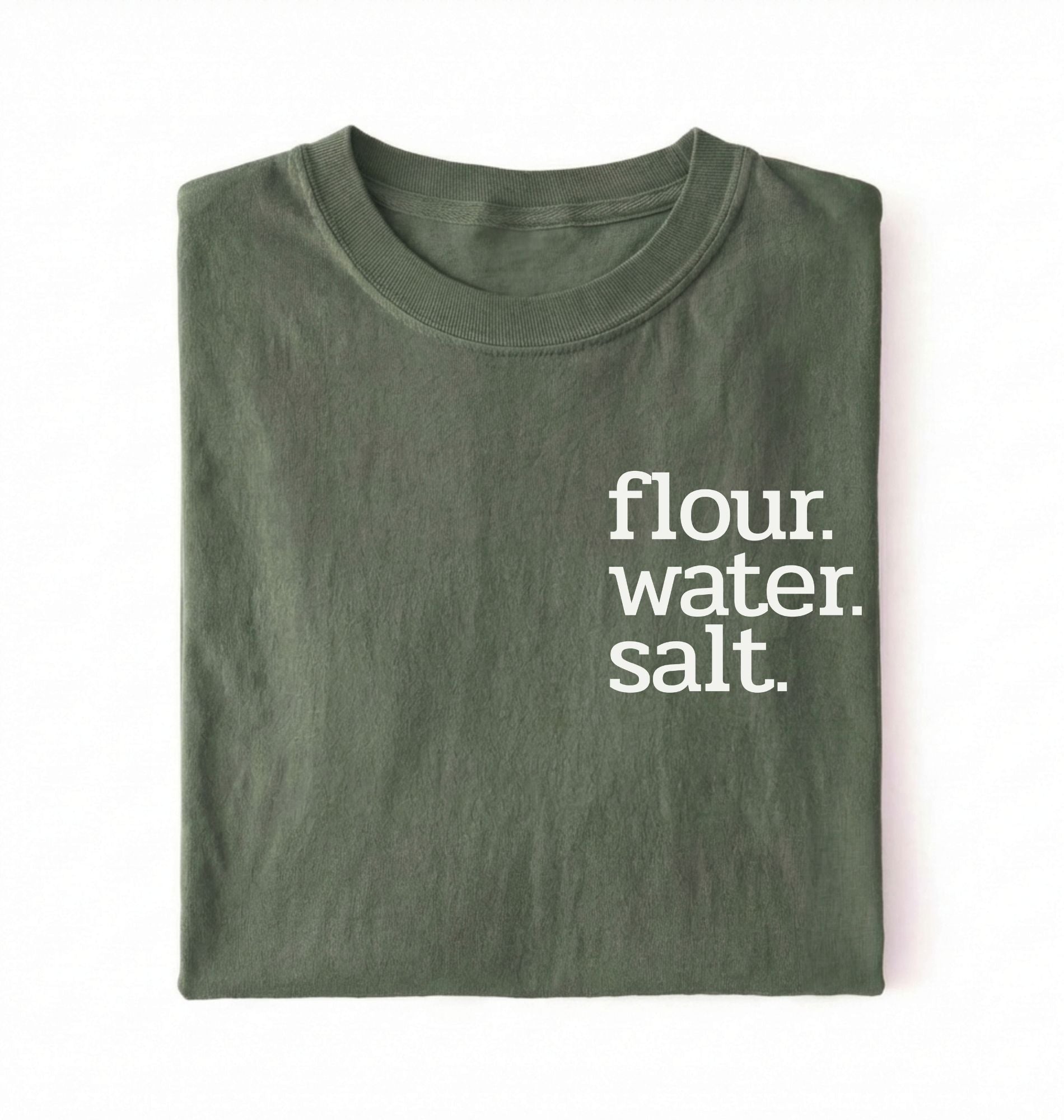Flat lay of a green flour water salt shirt black minimalist sourdough baking t shirt bread lover gift simple design on a white background 