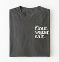 Flat lay of a pepper flour water salt shirt black minimalist sourdough baking t shirt bread lover gift simple design on a white background 