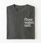 Flat lay of a pepper flour water salt shirt black minimalist sourdough baking t shirt bread lover gift simple design on a white background 